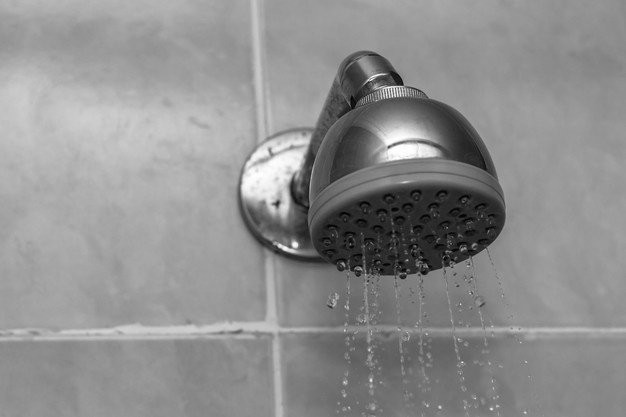 closeup-grayscale-shot-showerhead-with-water-dripping-down_181624-20446.jpg