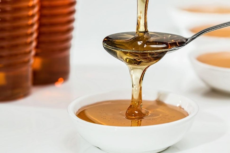 pouring-spoonful-of-honey-into-bowl.jpg