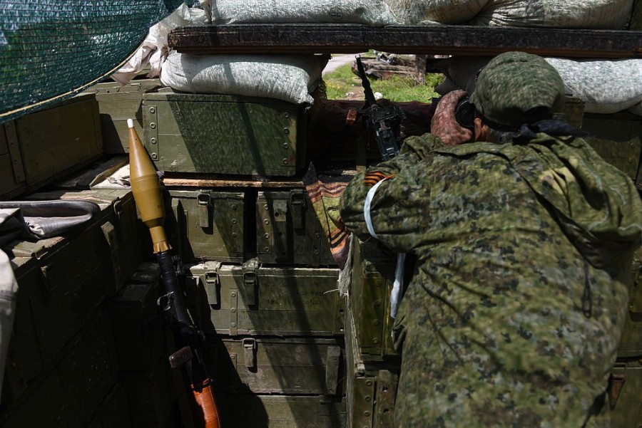 A_Russia-backed_rebel_observing_Ukrainian_army_positions_though_firing_port_at_his_position_near_Donetsk,_Eastern_Ukraine,_May_17_2015.jpg